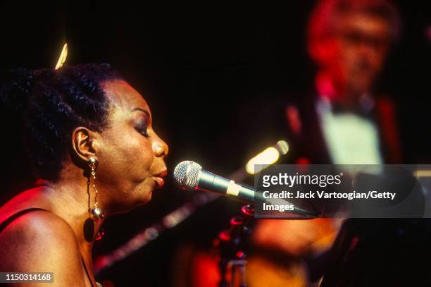 American musician and Civil Rights activist Nina Simone plays piano as she performs at the Beacon Theater, New York, New York, May 1, 1993. Obscured...