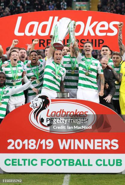 Scott Brown and Mikael Lustig of Celtic lift the league championship trophy in celebration after the Ladbrokes Scottish Premiership match between...