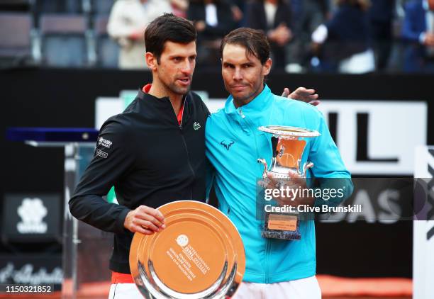 Rafael Nadal of Spain with his winners trophy and Novak Djokovic of Serbia with his runners up trophy after Nadal's three set victory in the men's...