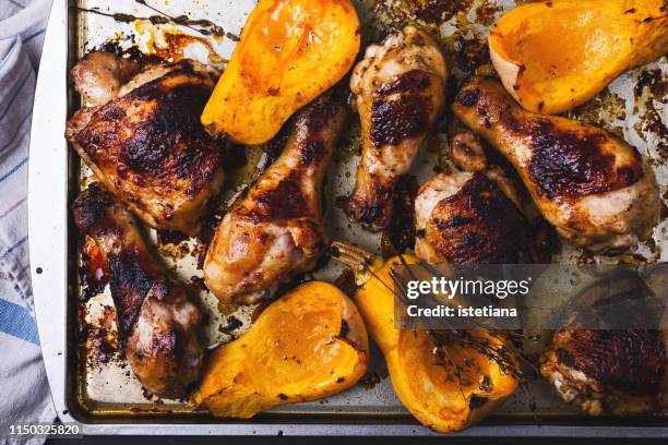 baked chicken legs, butternut squash and thyme herb background - table dinner winter imagens e fotografias de stock