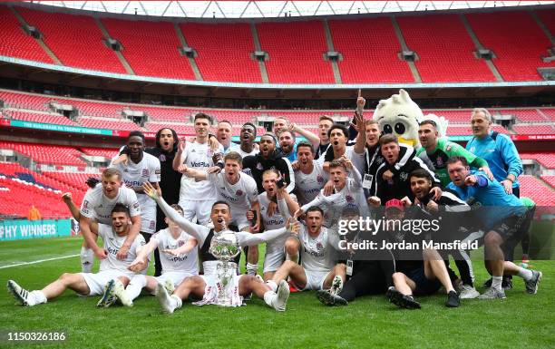 Flyde players celebrate with the trophy at the end of the FA Trophy Final match between Leyton Orient and AFC Fylde at Wembley Stadium on May 19,...