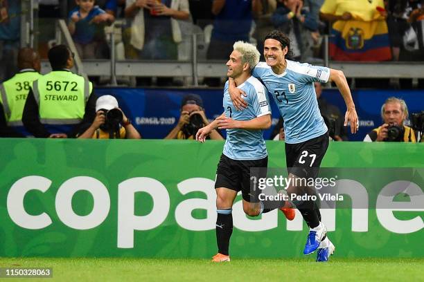 Nicolas Lodeiro of Uruguay celebrates with teammate Edinson Cavani after scoring the first goal of his team during a match between Uruguay and...