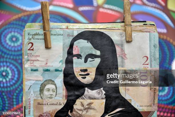 Reproduction of the Mona Lisa painted on devalued Bolivares Fuertes bills by Venezuelan communications student Kristian Vasquez, 27 year-old, is...