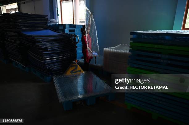 In this photo taken on April 23 an employee works at the Luzhou Loajian bottling plant in Luzhou, southwestern China's Sichuan province. - Baijiu's...