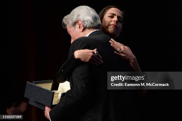 Alain Delon accepts the Palme d'Or d'Honneur award from his daughter Anouchka Delon during the Ceremony for Palme Honneur during the 72nd annual...