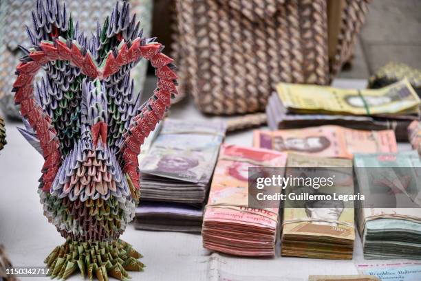 Handicraft made with Venezuelan devalued and out of circulation banknotes Bolivares Fuertes, is exhibited for sale by Colombian designer Luis Orlando...