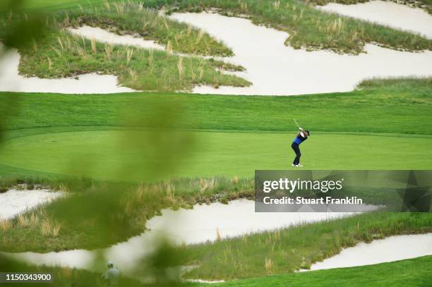 Brooks Koepka of the United States plays a shot on the fourth hole during the final round of the 2019 PGA Championship at the Bethpage Black course...