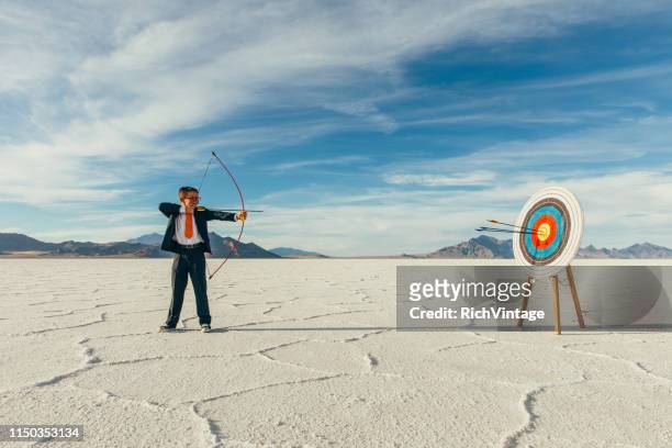successful business boy with arrows in target - bullseye target stock pictures, royalty-free photos & images