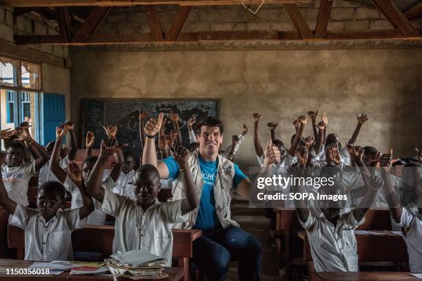 Retired Irish rugby player and UNICEF Ambassador Donncha O'Callaghan poses for a picture in a classroom of children being taught about the symptoms...