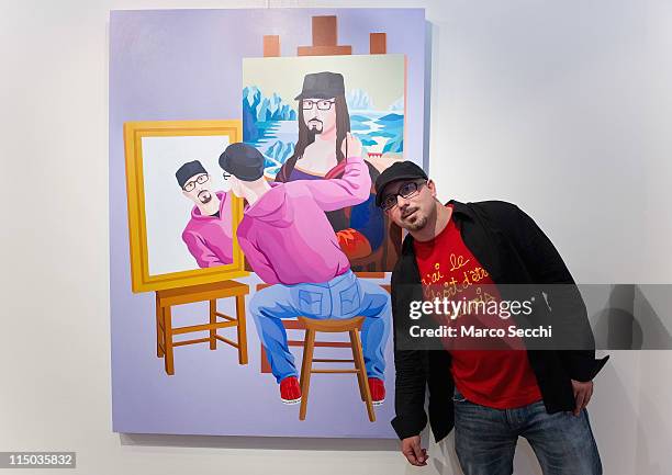 Artist Giuseppe Veneziano stands in front of hos portrait at Galleria Contini on June 1, 2011 in Venice, Italy.