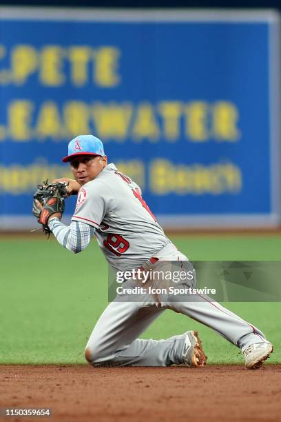 Wilfredo Tovar of the Angels throws the ball over to first base while on one knee for the out during the MLB regular season game between the Los...