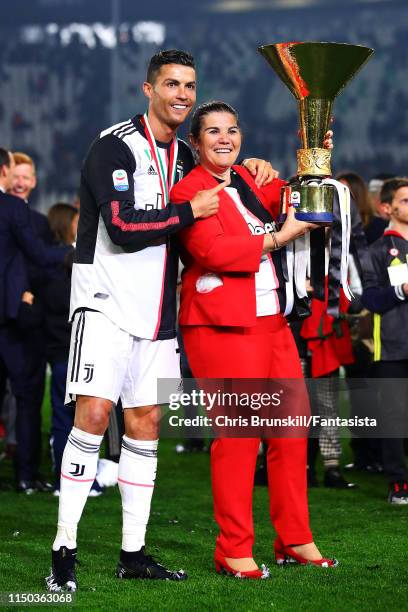 Cristiano Ronaldo of Juventus poses with the Serie A trophy alongside his mother Maria Dolores dos Santos Aveiro following the Serie A match between...