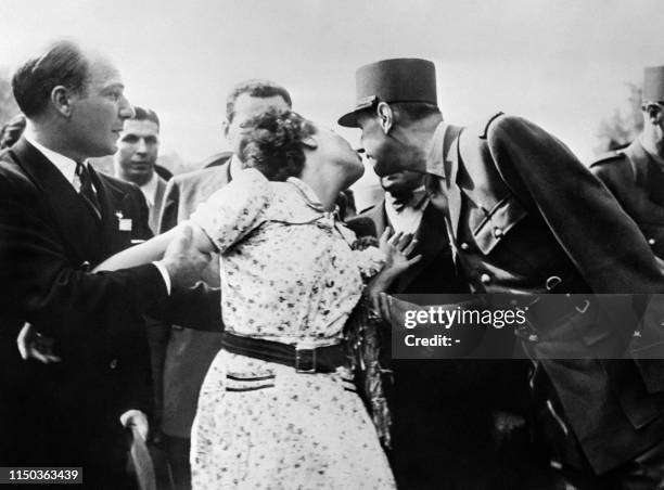 Picture dated 24 August 1944 showing a Parisian woman kissing French General de Gaulle during a parade on the Champs-Elysees after Paris' liberation....