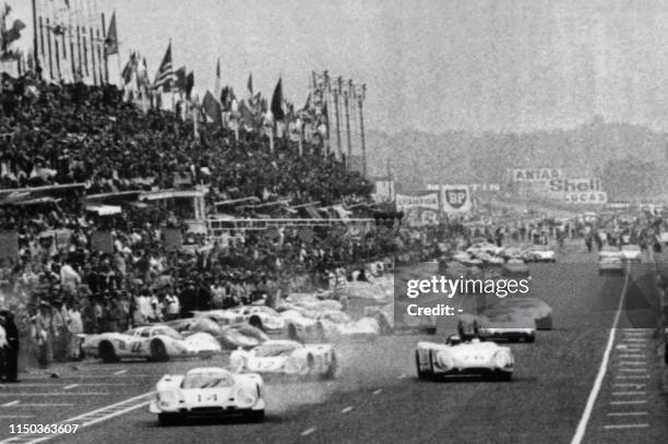 Race cars take the start of the 37th edition of the 24 hours of Le Mans on June 15, 1969 on the circuit de la Sarthe in Le Mans, western France. -...