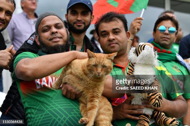 Bangladesh fan in the crowd holds Brian The Cat, the Somerset Cricket club cat, in the crowd during the 2019 Cricket World Cup group stage match...