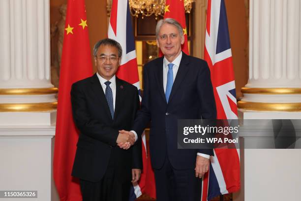 British Chancellor of the Exchequer Philip Hammond greets China's Vice-Premier Hu Chunhua on arrival at Mansion House on June 17, 2019 in London,...