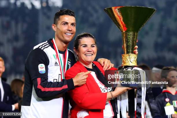 Cristiano Ronaldo of Juventus poses with the Serie A trophy alongside his mother Maria Dolores dos Santos Aveiro following the Serie A match between...