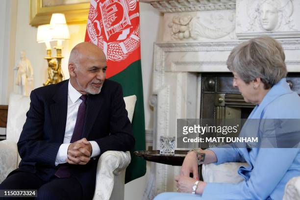 British Prime Minister Theresa May speaks with Afghanistan's President Ashraf Ghani at the start of their meeting inside 10 Downing Street in London...