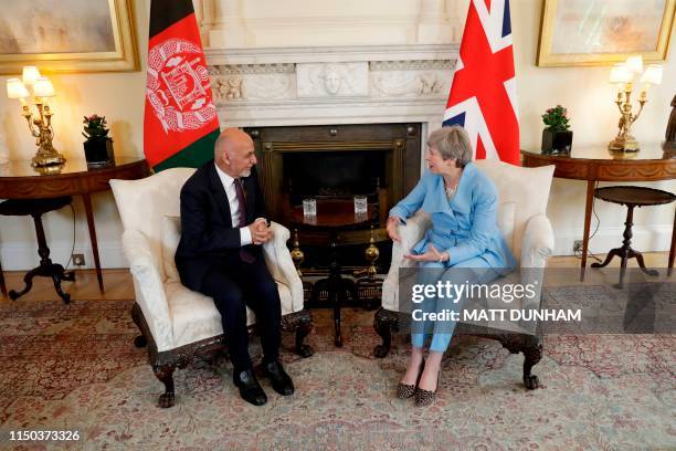 British Prime Minister Theresa May speaks with Afghanistan's President Ashraf Ghani at the start of their meeting inside 10 Downing Street in London...