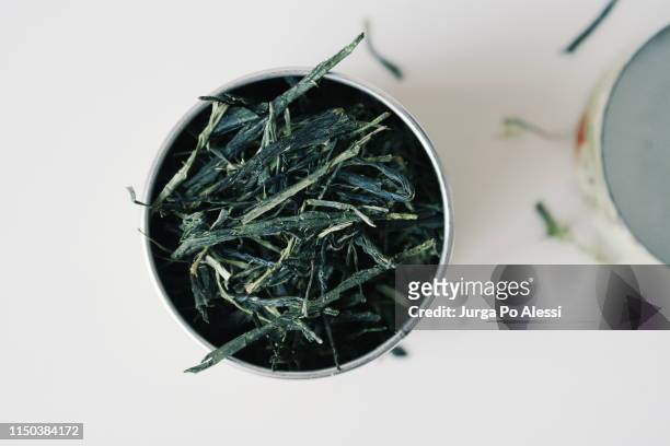 flat lay of japanese tea caddy with dry leaves of sencha green tea. - sencha tea stock pictures, royalty-free photos & images