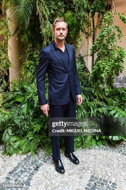 Swedish actor Alexander Skarsgard poses as he arrives to attend the presentation of fashion house Armani's women's and men's spring/summer 2020...