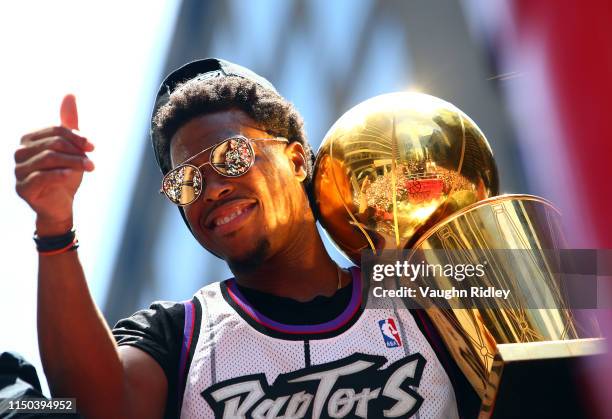 Kyle Lowry of the Toronto Raptors holds the championship trophy during the Toronto Raptors Victory Parade on June 17, 2019 in Toronto, Canada. The...