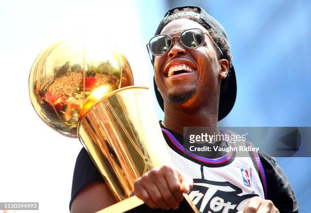 Kyle Lowry of the Toronto Raptors holds the championship trophy during the Toronto Raptors Victory Parade on June 17, 2019 in Toronto, Canada. The...