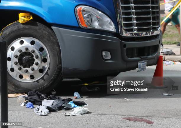 Police tape off Bay Street as they investigate a shooting or stabbing as the Toronto Raptors hold their victory parade after beating the Golden State...
