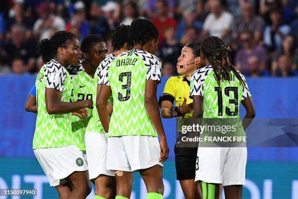 Nigeria's players react to Honduran referee Melissa Borjas after she ruled a French penalty be re-hit due to the goalkeeper moving off the goal line...