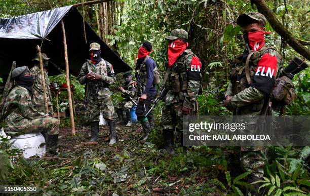 Members of the Ernesto Che Guevara front, belonging to the National Liberation Army guerrillas, stand at an improvised camp in the Choco jungle,...