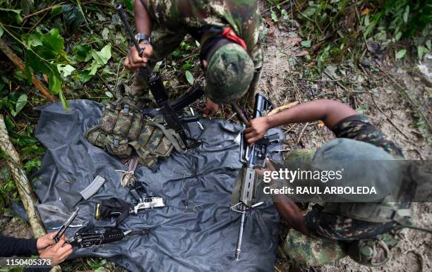Members of the Ernesto Che Guevara front, belonging to the National Liberation Army guerrillas, clean theirs weapons in the jungle, in Choco...