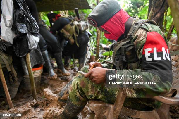 Members of the Ernesto Che Guevara front, belonging to the National Liberation Army guerrillas, fill hobbies in a improvised camp in the jungle, in...