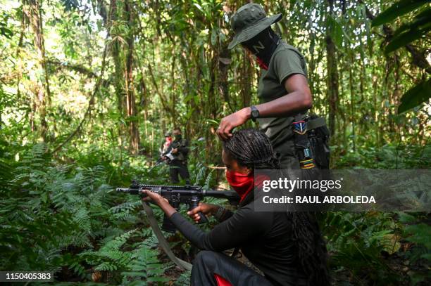 Members of the Ernesto Che Guevara front, belonging to the National Liberation Army guerrillas, shoot during a training in the jungle, in Choco...