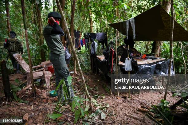 Members of the Ernesto Che Guevara front, belonging to the National Liberation Army guerrillas, stand in a improvised camp in the jungle, in Choco...