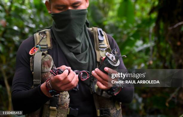 Member of the Ernesto Che Guevara front, belonging to the National Liberation Army guerrillas, carries a landmine as part of his weapons in the...