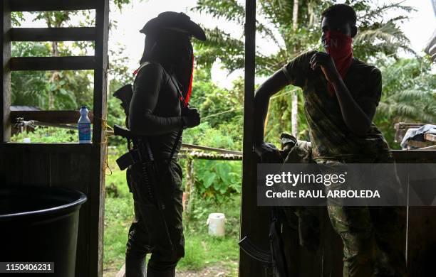 Members of the Ernesto Che Guevara front, belonging to the National Liberation Army guerrillas, wait in a house next to the jungle, in Choco...