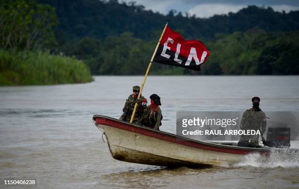 Members of the Ernesto Che Guevara front, belonging to the National Liberation Army guerrillas, patrols the river at the jungle, in Choco department...