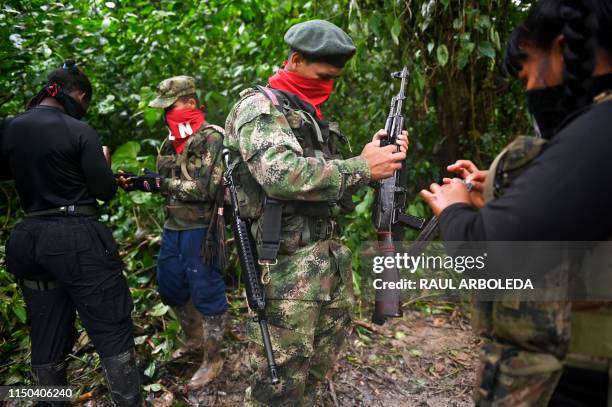 Members of the Ernesto Che Guevara front, belonging to the National Liberation Army guerrillas, clean theirs weapons in the jungle, in Choco...
