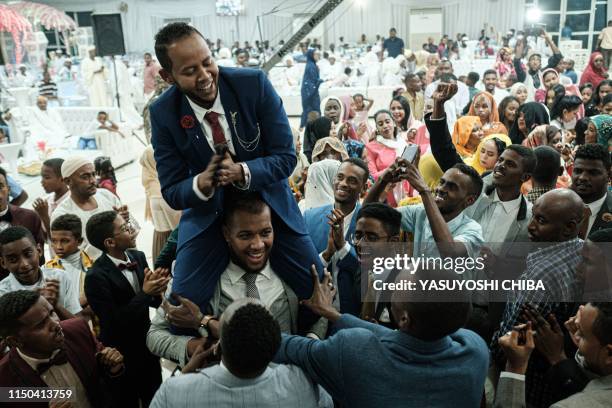 Sudanese IT engineer is carried by his friends during his wedding in Khartoum, Sudan, on June 16, 2019.