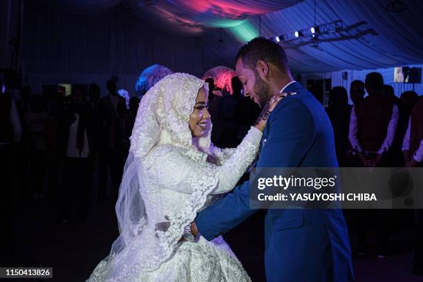 Sudanese bride, a 23-year-old dentist, and a27-year-old IT engineer, both working in Saudi Arabia, hold their wedding ceremony in Khartoum, Sudan, on...