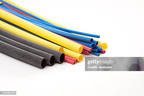 colorful ends of assorted pipes on white background - pvc stockfoto's en -beelden