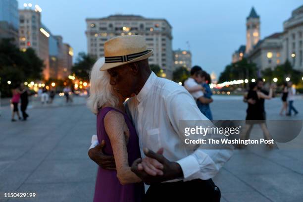Ginette Kayser and Wesley Taylor dance with the Argentine tango group, Capital Tangueros, on June 16, 2019 at Freedom Plaza in Washington, DC. The...