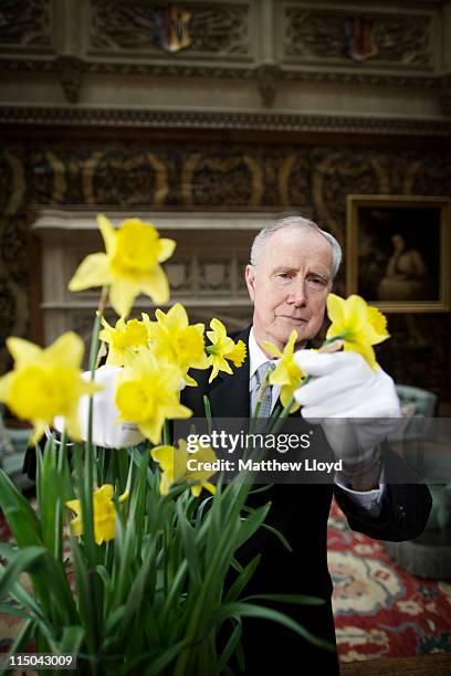 Colin the butler tends to some flowers in the saloon at Highclere Castle on March 15, 2011 in Newbury, England. Highclere Castle has been the...