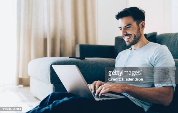 smiling man using laptop - free images without copyright stock pictures, royalty-free photos & images