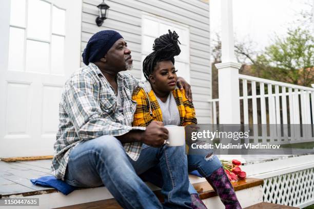 father and daugther sitting on stairs and drinking coffee - season 61 stock pictures, royalty-free photos & images