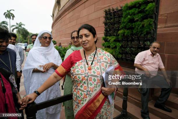 Smriti Irani, minister of women and child development, leaves Parliament House during the first day of the 17th Lok Sabha in New Delhi, India, on...