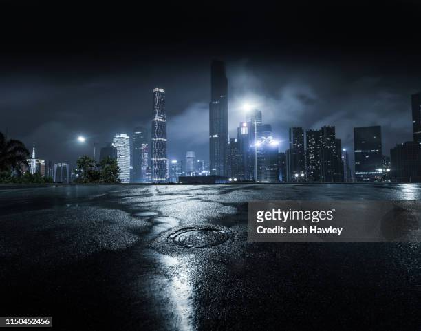 city parking lot and square - raining city at night stock-fotos und bilder