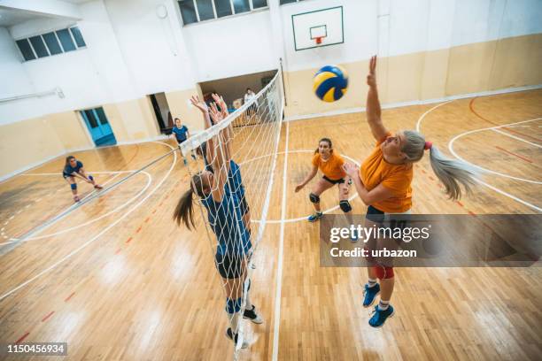 female volleyball player spiking the ball - spike stock pictures, royalty-free photos & images