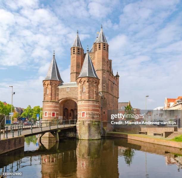 the amsterdamse poort, a former city gate and historic landmark in haarlem, netherlands. - moat stock pictures, royalty-free photos & images
