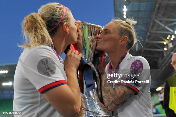 Eugénie Le Sommer and Jessica Fishlock of Olympique Lyonnais kissing the trophy after the UEFA Women's Champions League Final between Olympique...